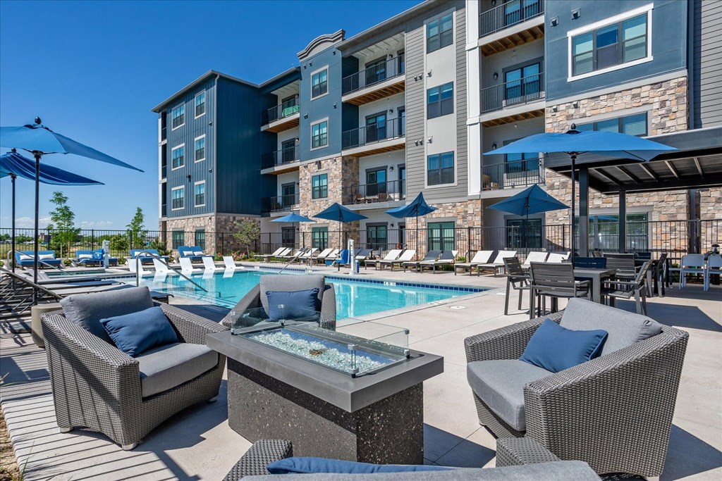 our apartments have a pool and lounge area with chairs and umbrellas