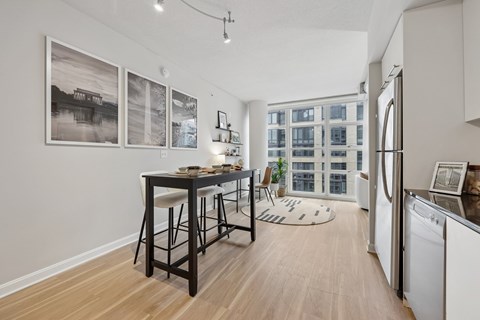 A kitchen with a table and chairs in the middle of the room.
