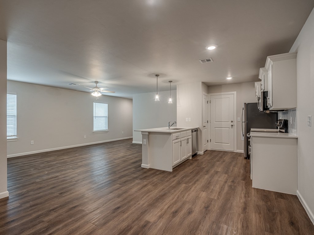 a kitchen and living room with hardwood floors