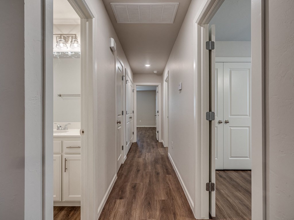 a bedroom with a medium sized bed and a mirror on the wall