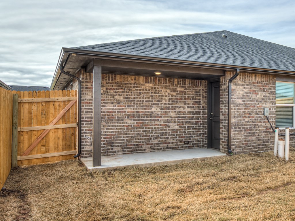 a garage with a wooden gate and a brick wall