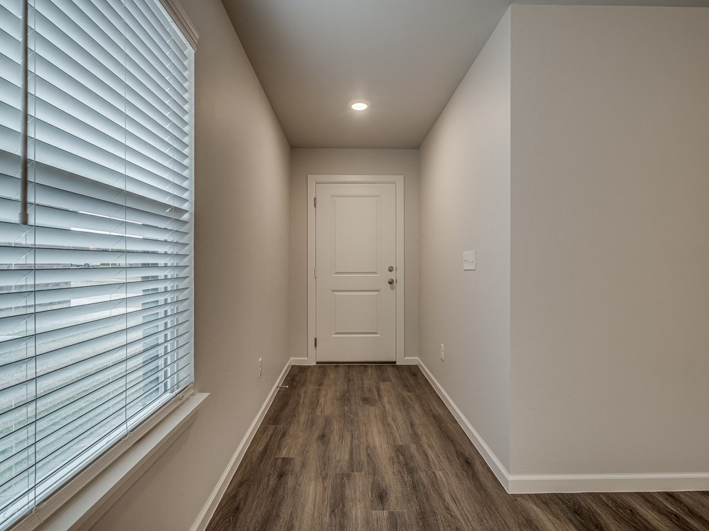a bedroom with a large window and a white door