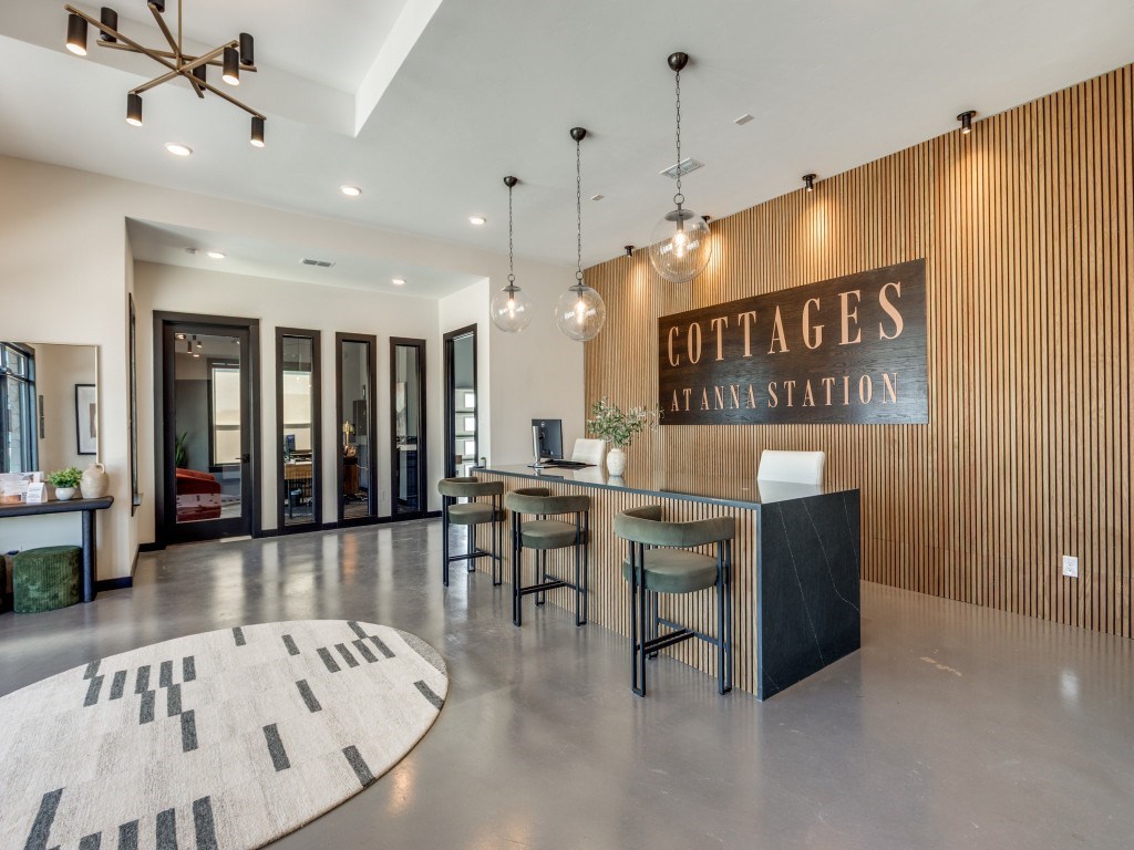 A modern lobby with a reception desk and a sign that says