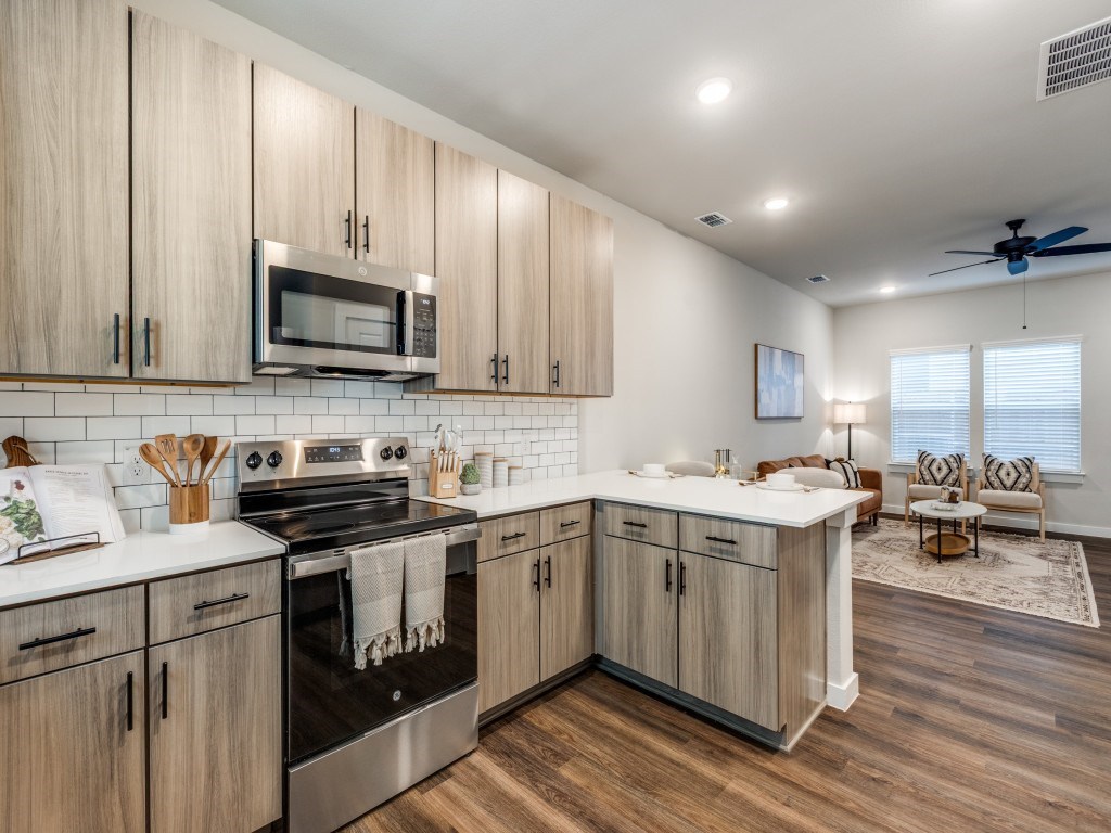 A modern kitchen with wooden cabinets and stainless steel appliances.