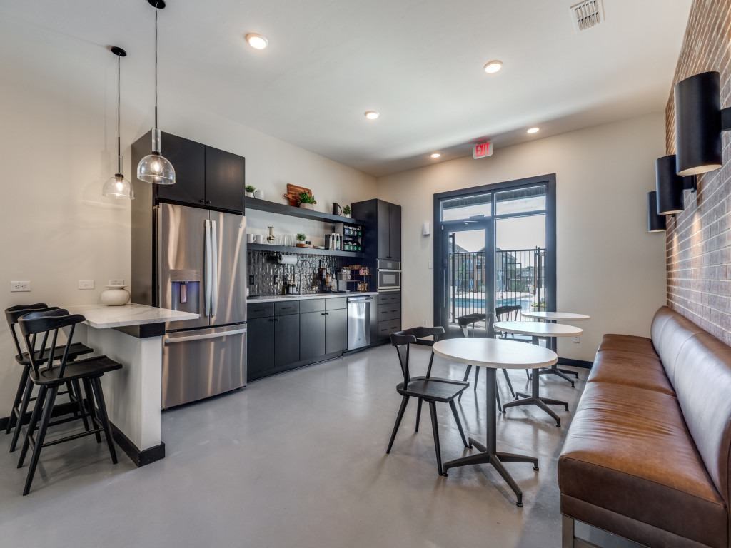 A modern kitchen with a bar area and seating.