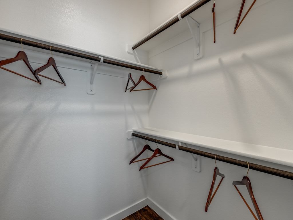 Closet with hangers on the wall.