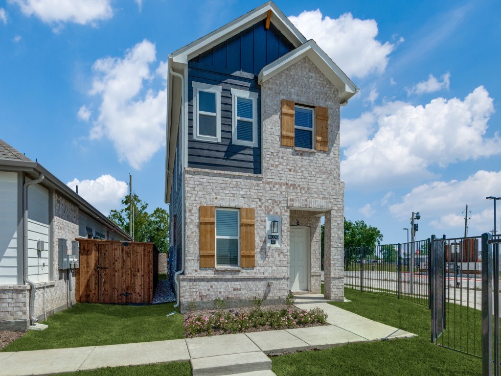 A blue house with a white door and windows.