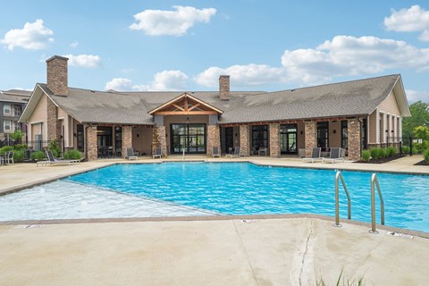 A large house with a pool in front.