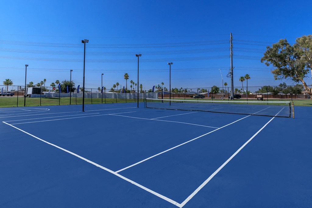 two tennis courts at the enclave at woodbridge apartments in sugar land, tx