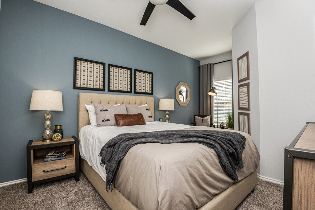 a bedroom with a bed and a ceiling fan