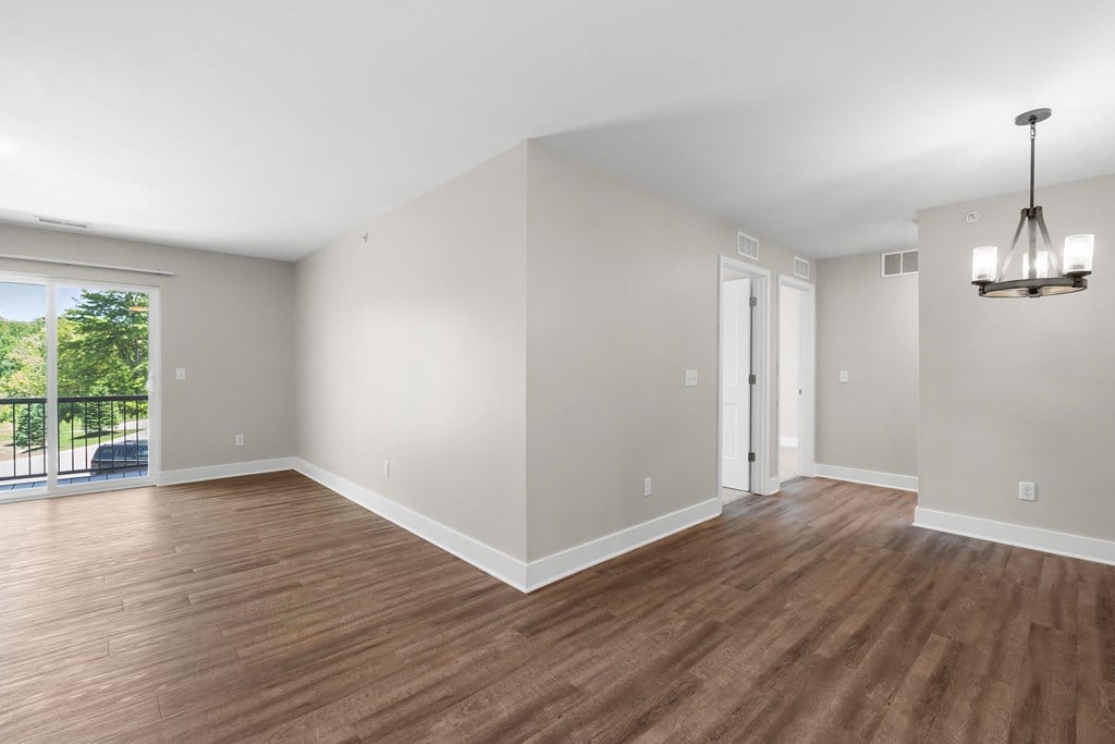 A room with wooden floors and white walls.