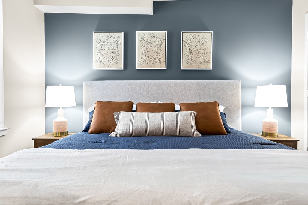 a bedroom with a bed and a blue wall