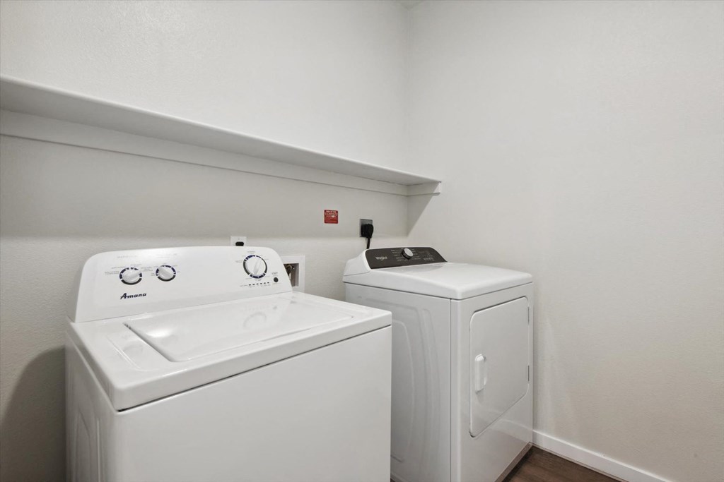 a washer and dryer in a room with a white wall and a white
