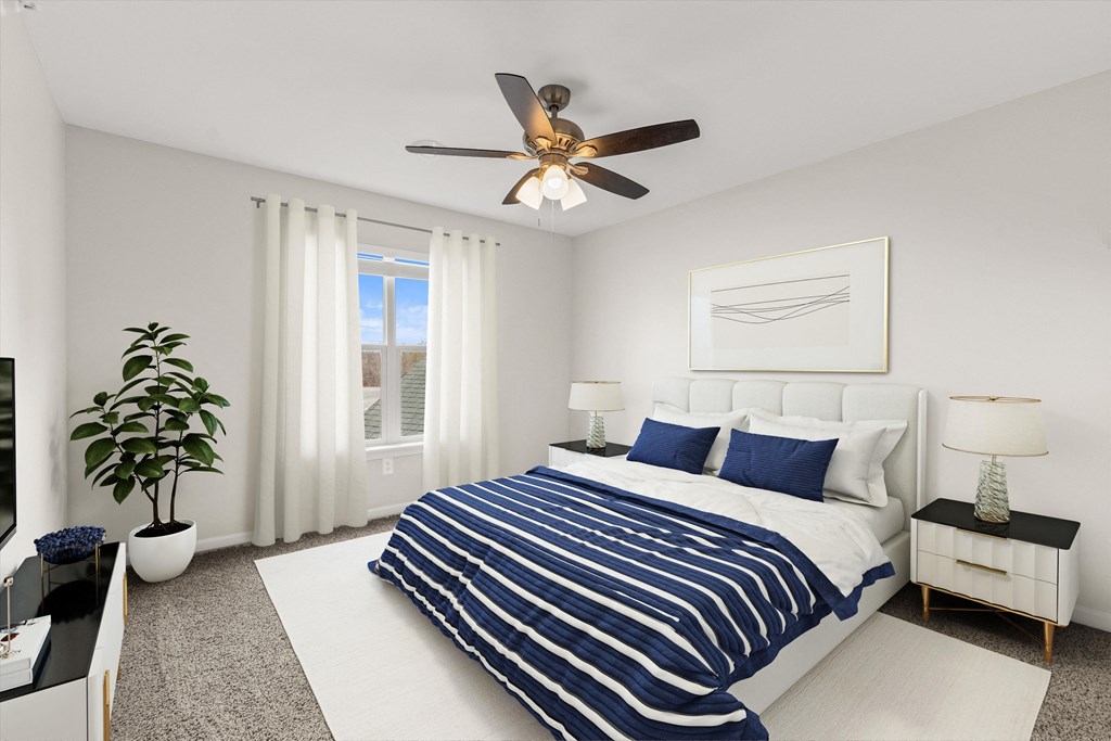 a bedroom with a large bed and a ceiling fan