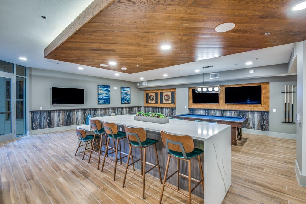 A bar area with a pool table and a TV.