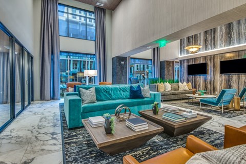 A modern living room with a blue couch and a coffee table.