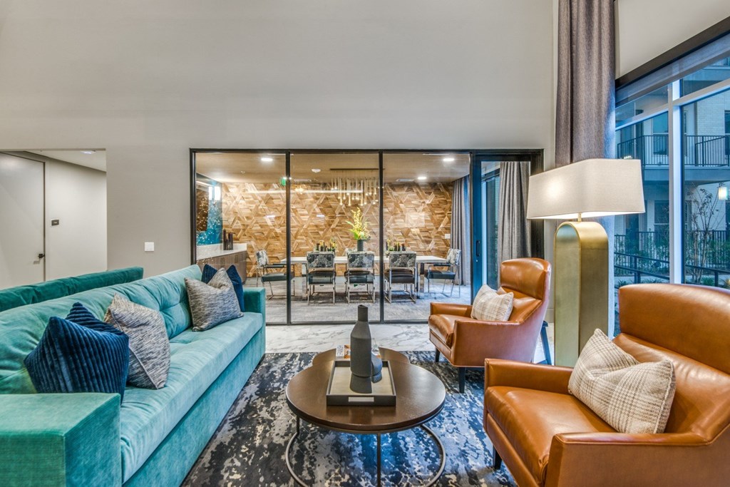 A living room with a blue couch and a brown armchair.