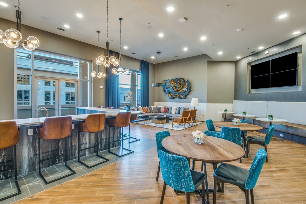 A modern dining area with a wooden table surrounded by chairs.