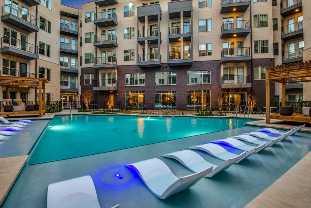 A large swimming pool with a blue light in the middle of it.