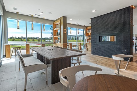 A modern dining room with a wooden table and chairs.