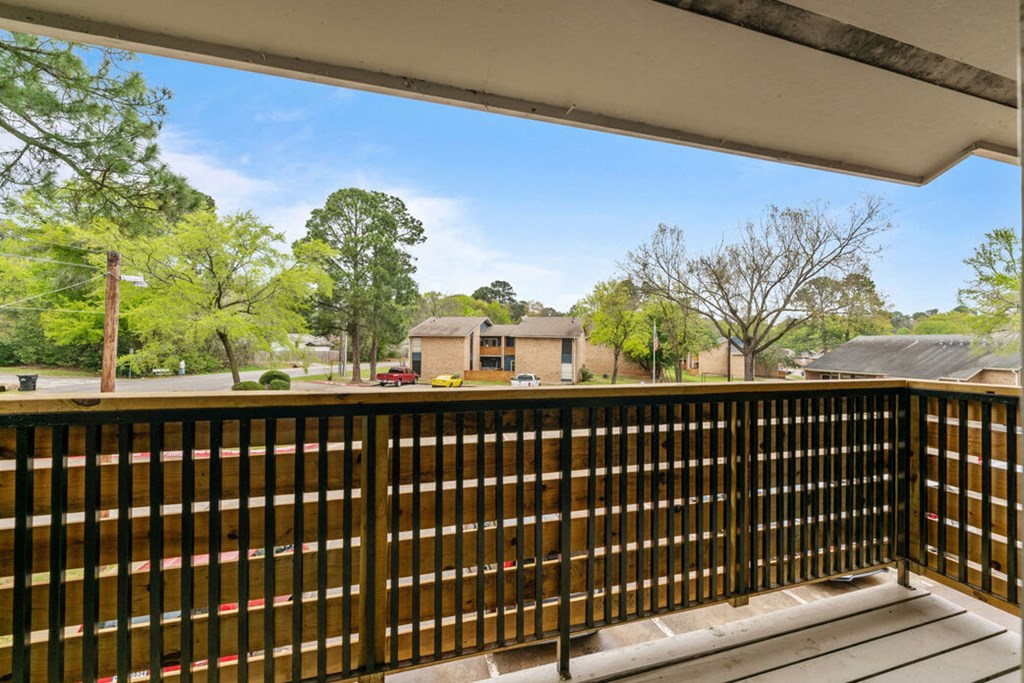 the deck has a view of the neighborhood from the balcony