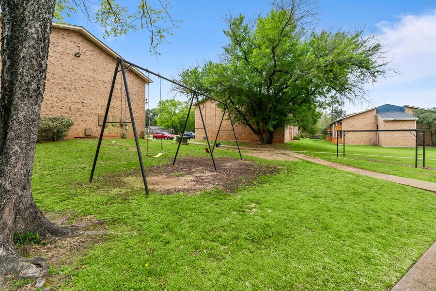 a swing set in a park next to a building