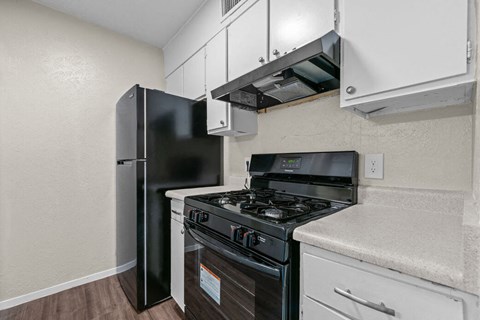 a kitchen with a stove and a refrigerator