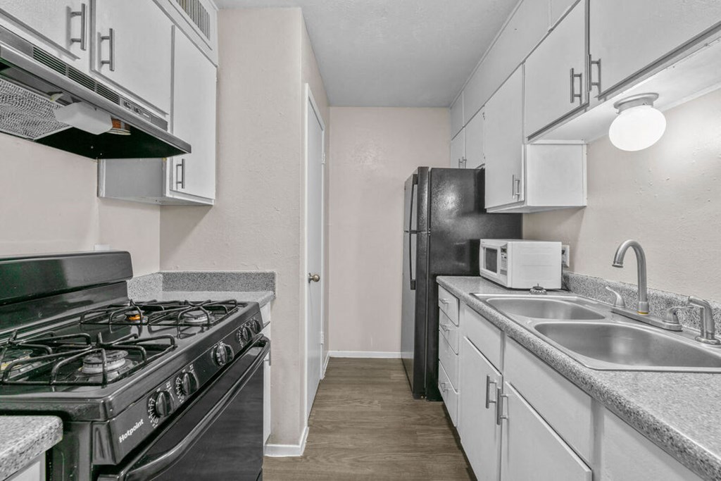 a kitchen with stainless steel appliances and white cabinets