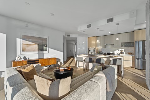 A modern living room with a grey sofa and a wooden coffee table.