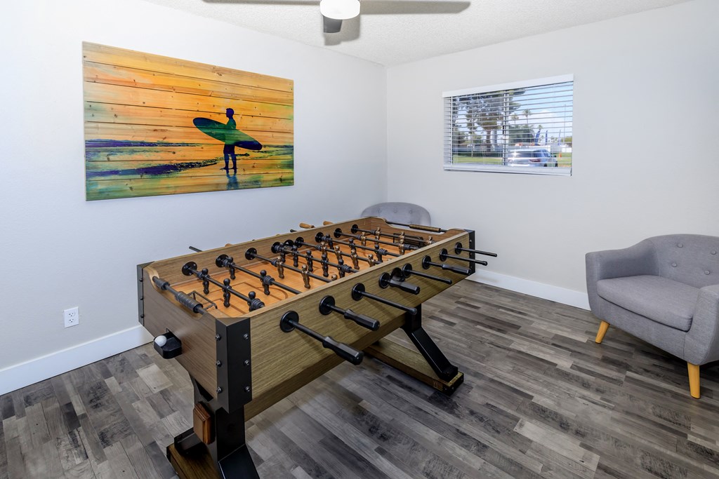 the games room has a foosball table and ping pong table
