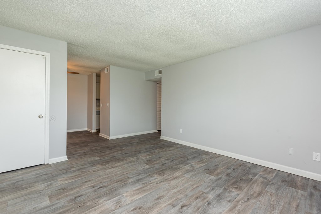 a bedroom with hardwood floors and grey walls