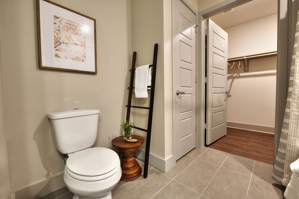 a bathroom with a toilet and a towel rack