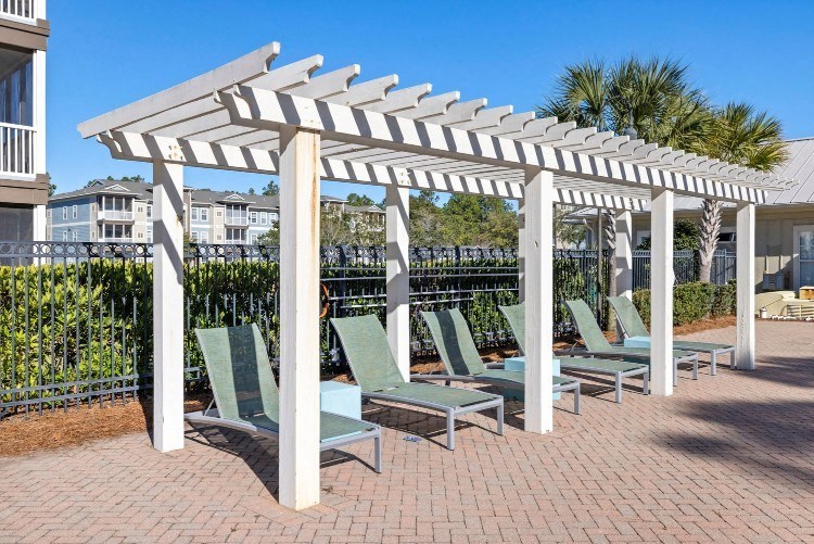 a row of chairs sitting under a white canopy