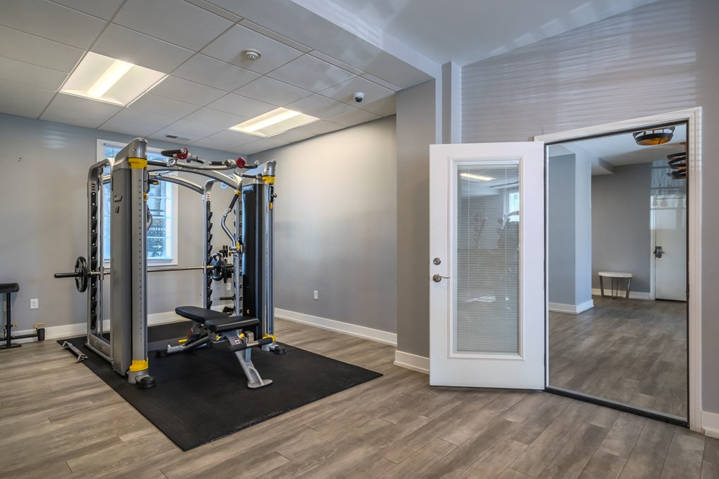 a gym with a exercise machine and an open door