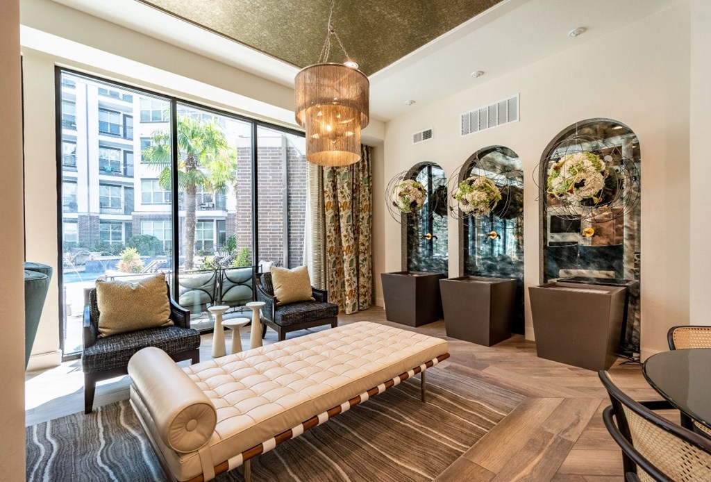 A living room with a large window and a view of a cityscape.