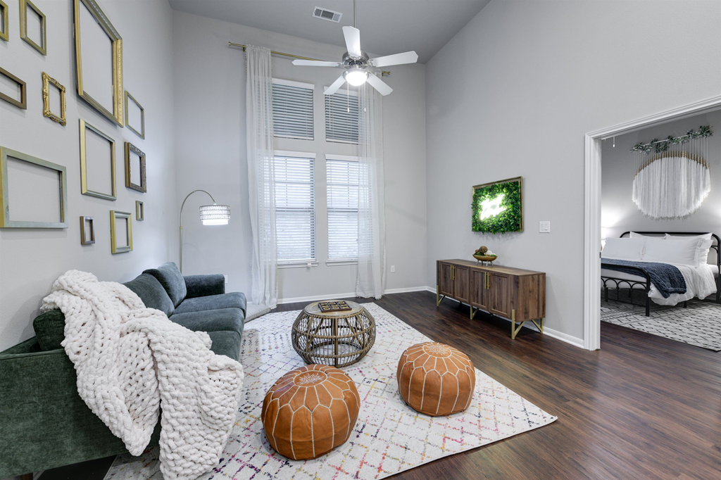 a living room with a couch and a ceiling fan
