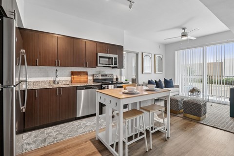 A modern kitchen with a dining table and chairs.
