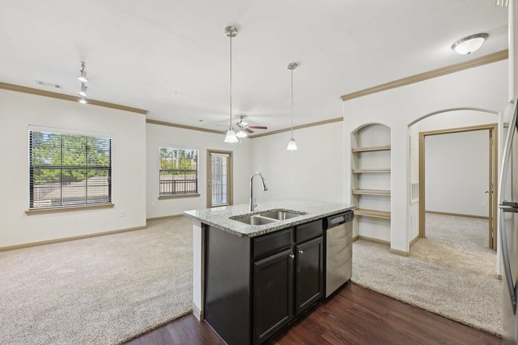 A kitchen with a sink and a refrigerator.