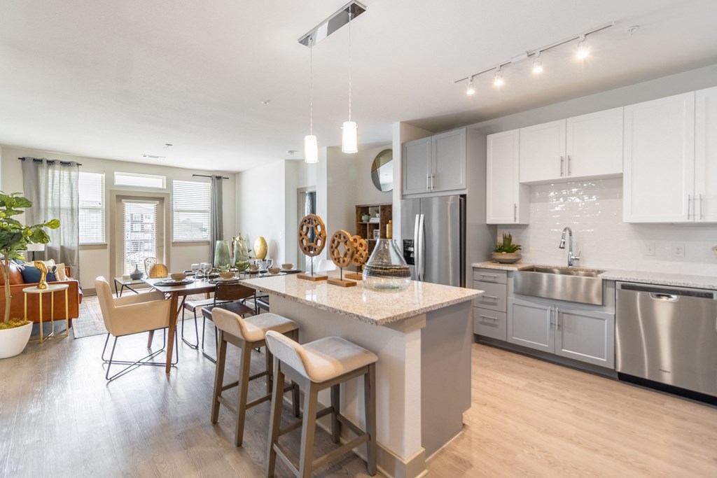 a kitchen and dining room with a large island and stainless steel appliances