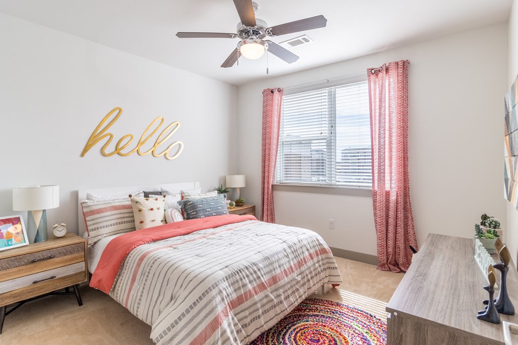 a bedroom with a bed and a ceiling fan