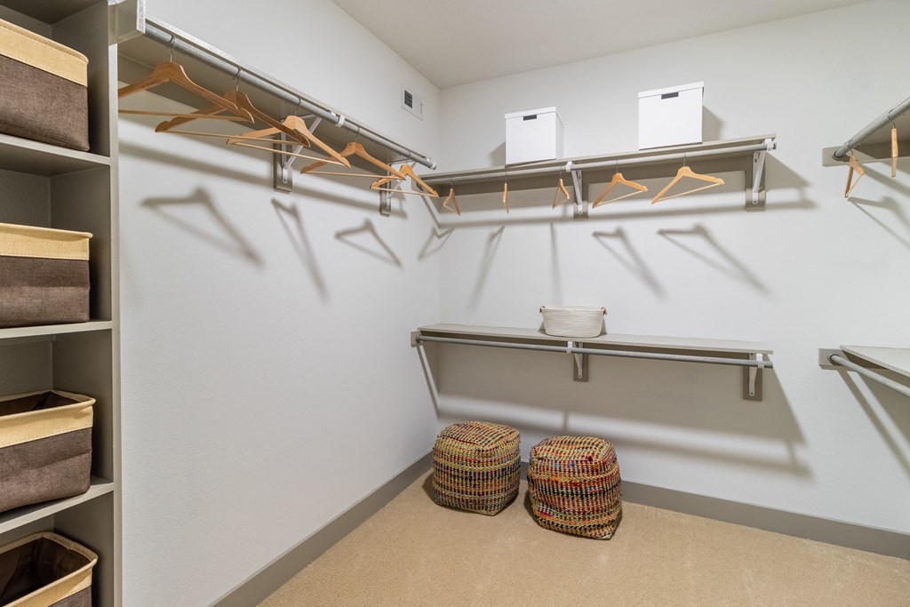 a spacious walk in closet with shelves and hangers