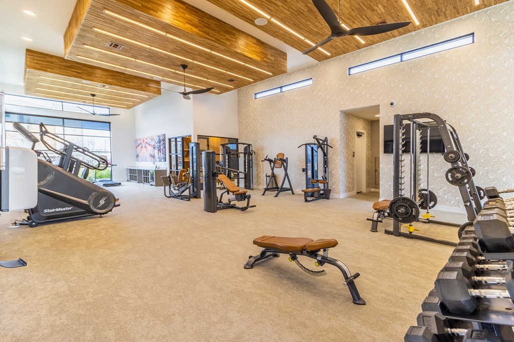 a spacious fitness center with treadmills and other exercise equipment