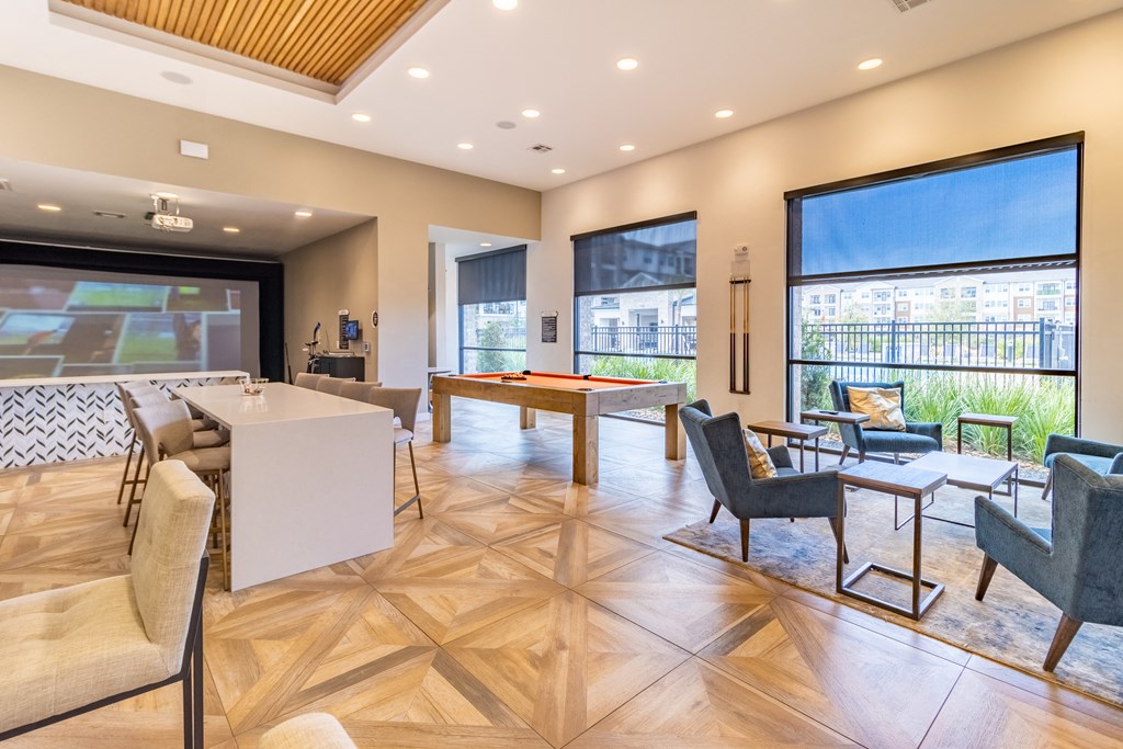 a resident clubhouse with a pool table and bar