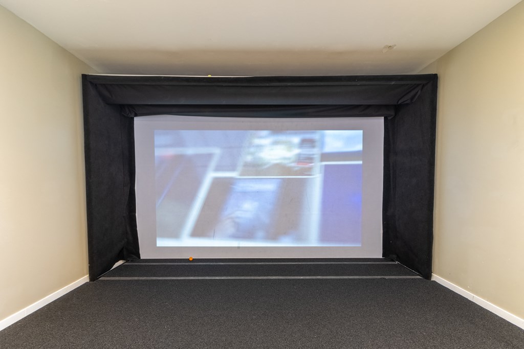 a large projection screen in a room with a carpeted floor