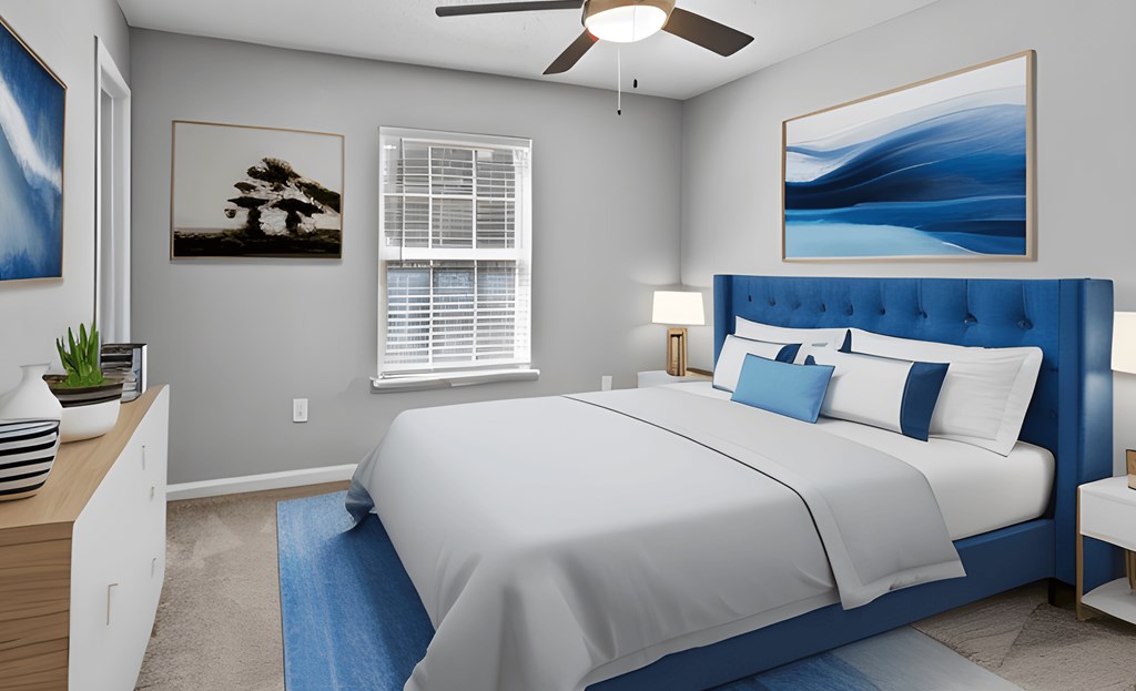 a bedroom with a large bed and a ceiling fan
