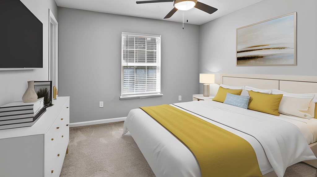 a bedroom with a large bed and a ceiling fan