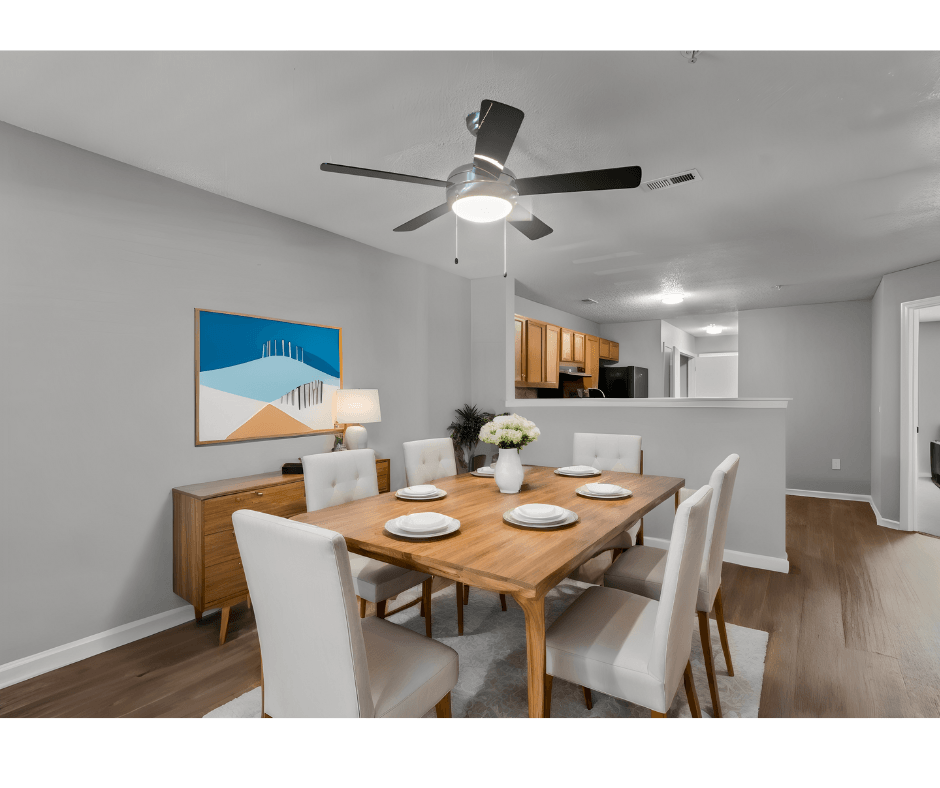 a dining room with a wooden table and chairs and a ceiling fan