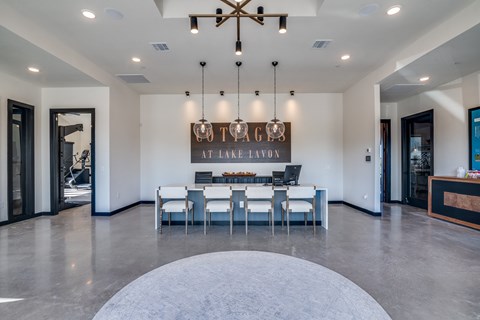 A modern dining room with a large table and chairs.
