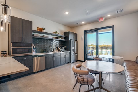 A modern kitchen with a dining table and chairs.