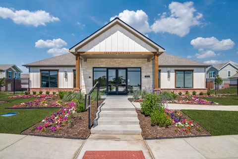 A building with a front yard and a sign that says "ENTRANCE".